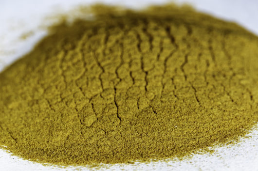 A front angled view of a small pile of Eschscholzia californica (California Poppy) 20x powder extract.